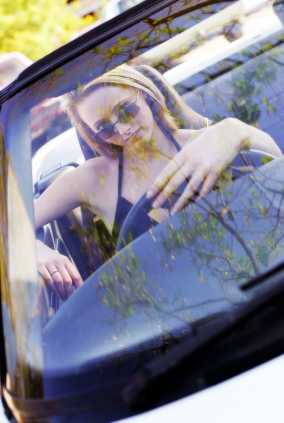 Sell Your Car Online For Free | Woman Sitting In Car Smiling
